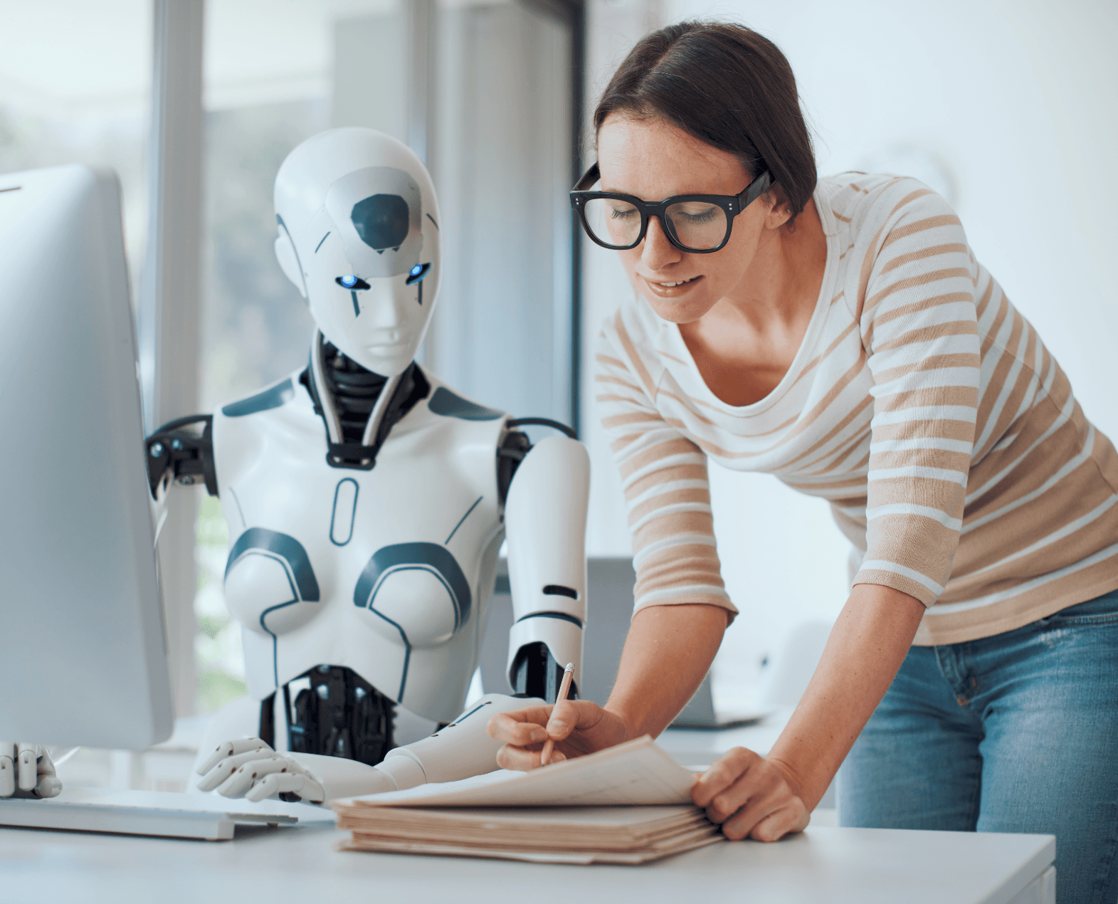 A humanoid robot listening to a young woman entrepreneur, who is talking about ai chatbots for business
